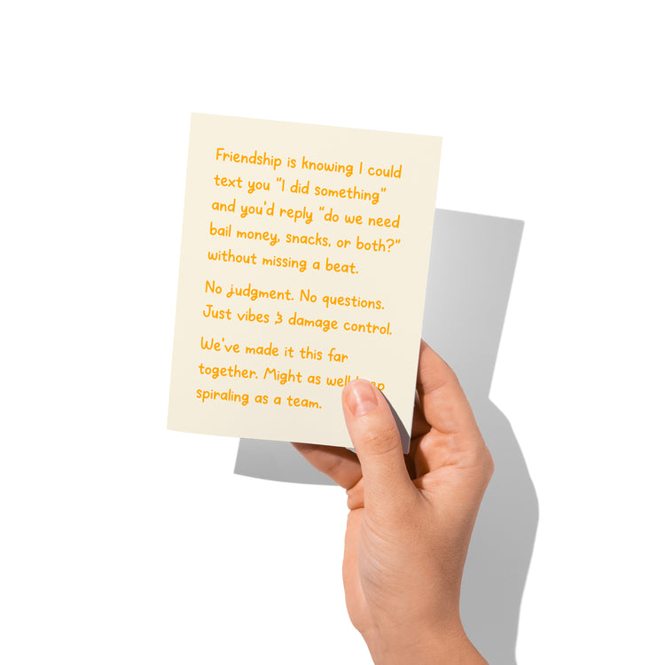 Funny friendship card held in hand, humorous best friend design.