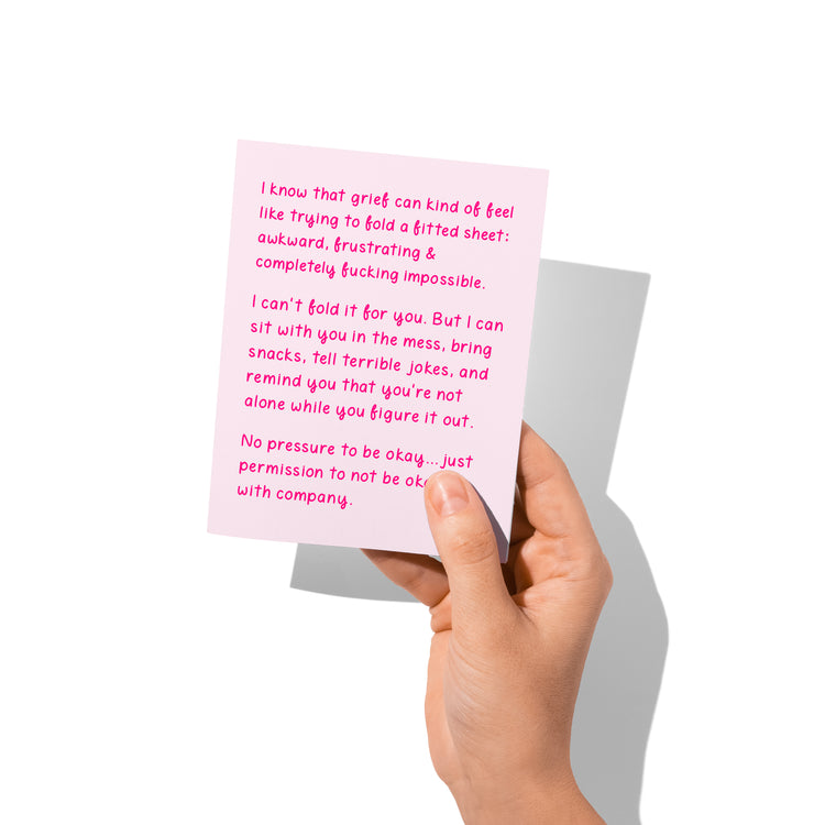 sympathy card held in hand, humorous grief support design visible.
