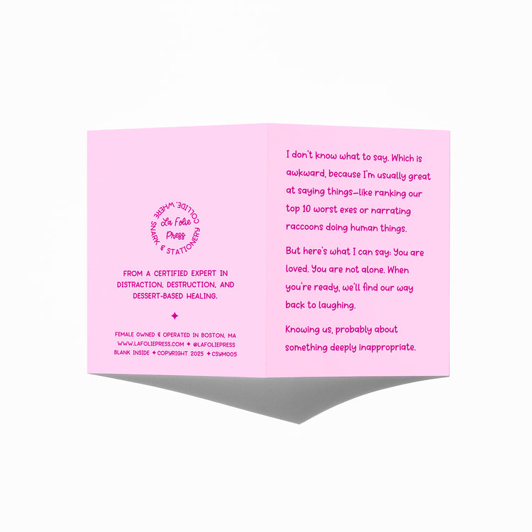 Funny sympathy card held in hand, humorous grief support message visible.