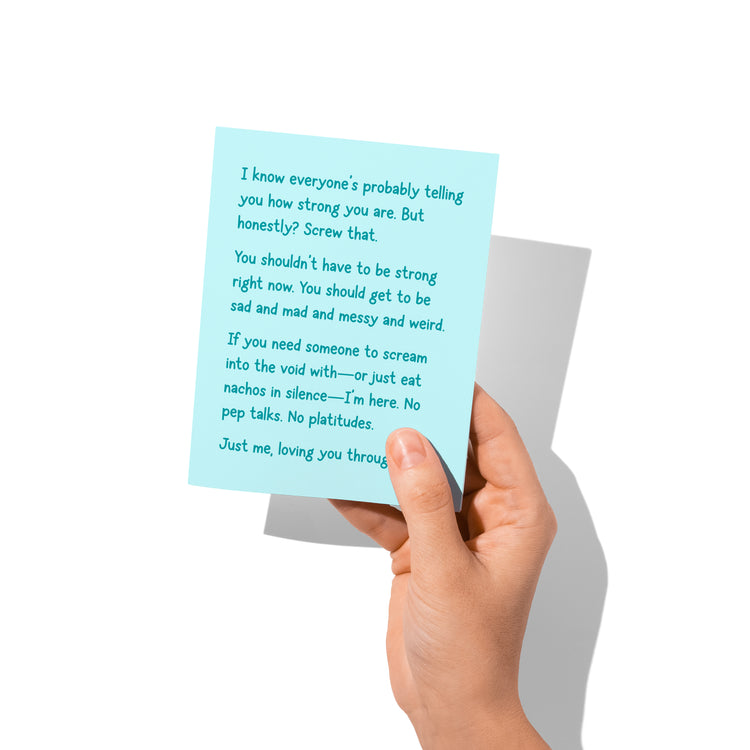 Sympathy card held in hand, close-up of snarky grief support message.
