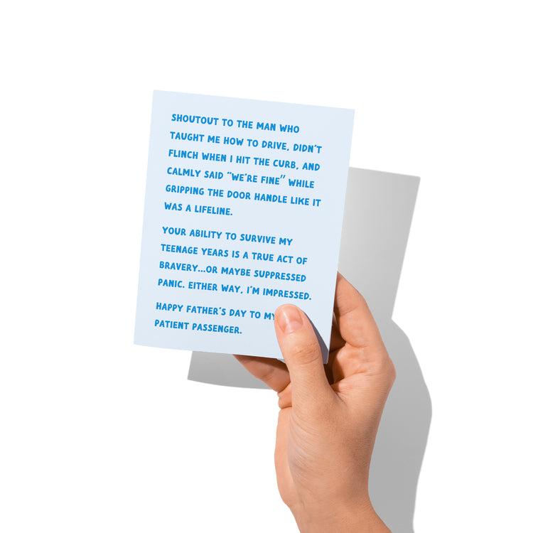 Hand holding a card with blue text on a white background