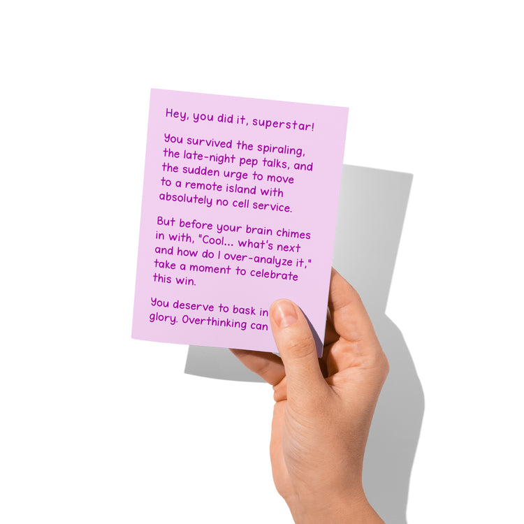 Funny congrats card held in hand, humorous achievement humor message visible.
