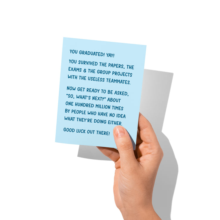 Funny graduation card held in hand, humorous graduation humor message visible.