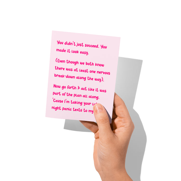 Funny congrats card held in hand, humorous chaotic success message visible.