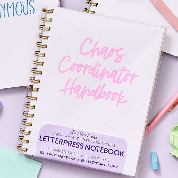 Funny letterpress notebook for multitaskers with bold pink text on white rigid cover.
