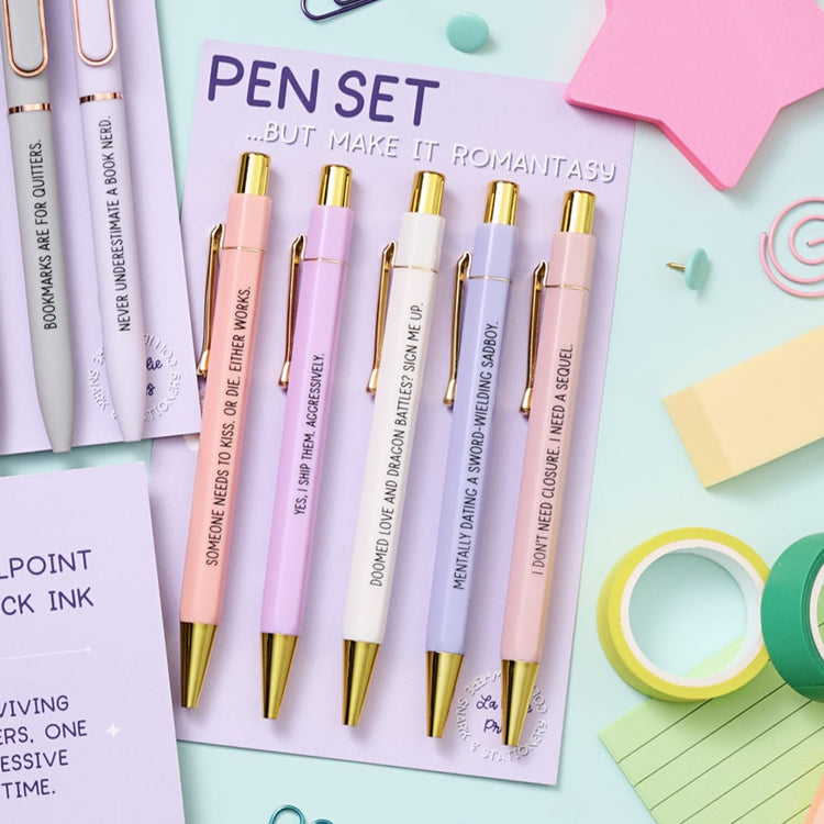 Romantasy-themed pen set with five pastel pens featuring humorous fantasy romance quotes, perfect gift for readers and book lovers.