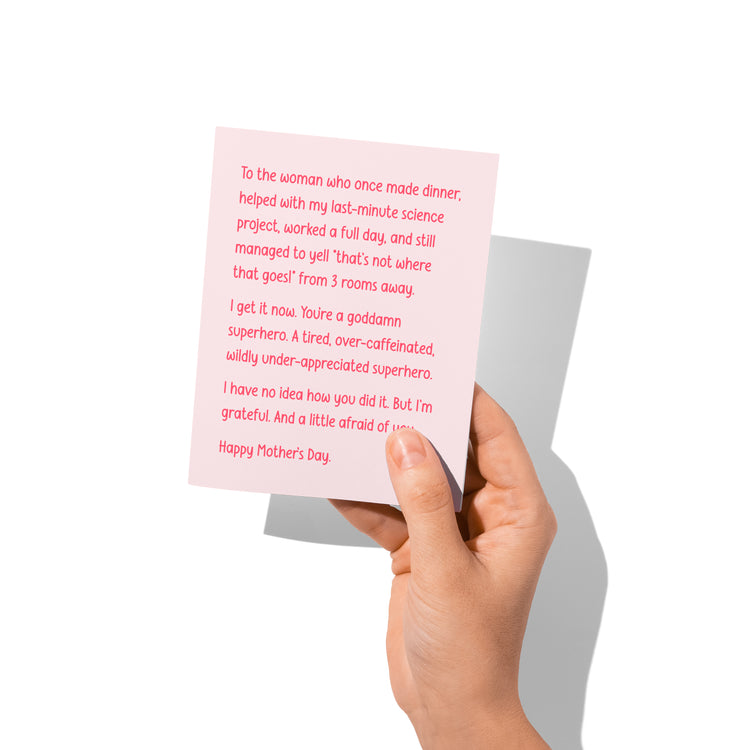 Funny Mother’s Day card held in hand, humorous mom message visible.