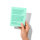 Funny holiday card held in hand, humorous holiday family chaos visible.