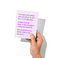 Funny love card held in hand, humorous love message visible.