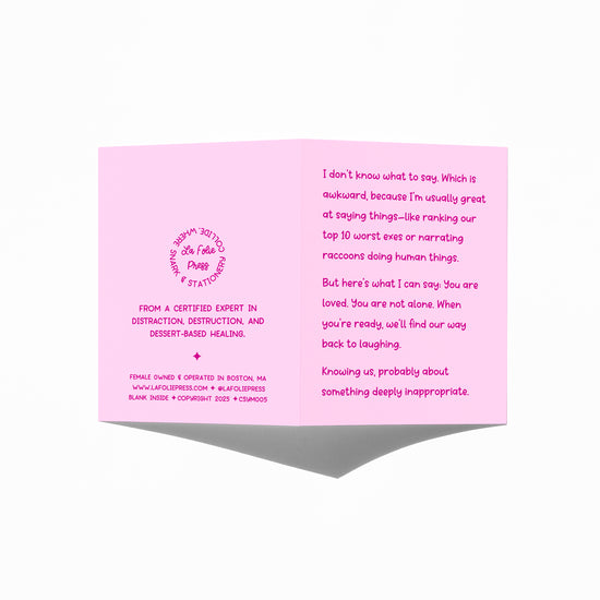 Funny sympathy card held in hand, humorous grief support message visible.