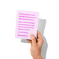Funny Valentine’s card held in hand, humorous love message visible.