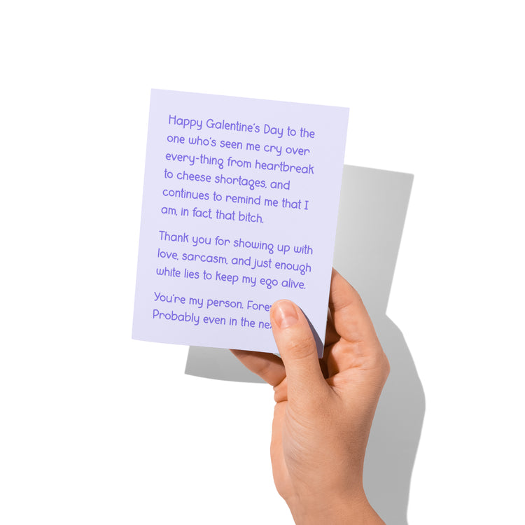 Funny Galentine’s card held in hand, humorous female friendship message visible.
