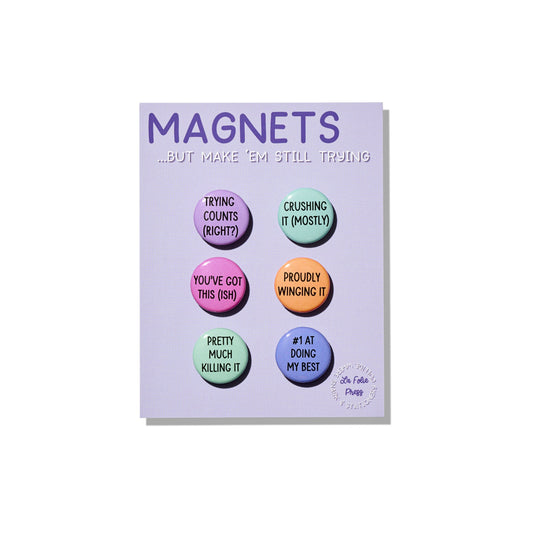 Still Trying Magnet Set with six colorful one-inch button magnets on backing card”