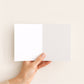 Funny new baby greeting card open to show blank inside.