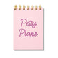 Pink letterpress mini jotter with magenta text “Petty Plans” and gold spiral binding.
