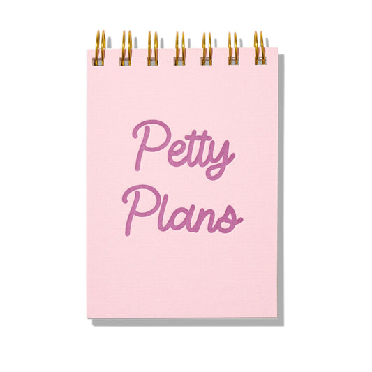 Pink letterpress mini jotter with magenta text “Petty Plans” and gold spiral binding.
