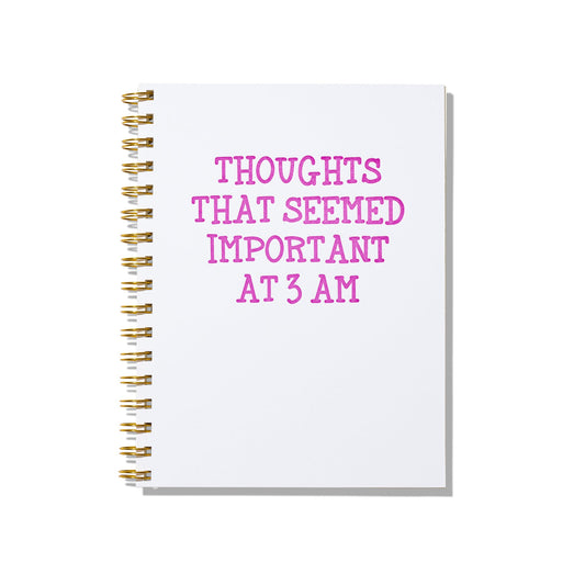 Large letterpress notebook with “Thoughts That Seemed Important at 3 AM” printed in magenta on a white cover with gold wire binding.