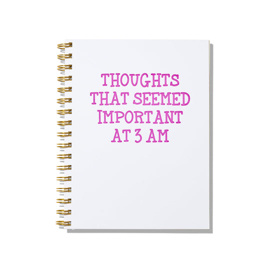 Large letterpress notebook with “Thoughts That Seemed Important at 3 AM” printed in magenta on a white cover with gold wire binding.