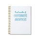 Large letterpress notebook with “Proud Member of Overthinkers Anonymous” in blue text on a white cover with gold spiral binding.
