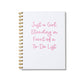 Large letterpress notebook with pink text “Just a Girl Standing in Front of a To-Do List” on white cover with gold spiral binding.
