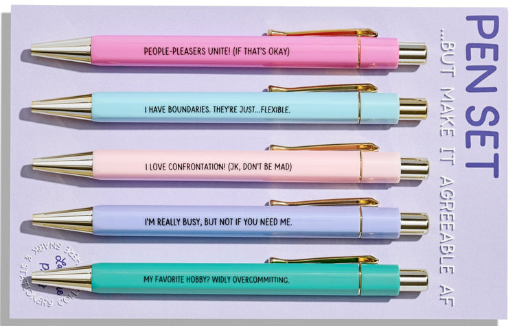 Set of five pastel pens with gold accents, each printed with funny people-pleasing quotes, on branded backing card.