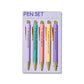 Five pastel ballpoint pens with gold accents, each printed with funny procrastination phrases, displayed on branded backing card.