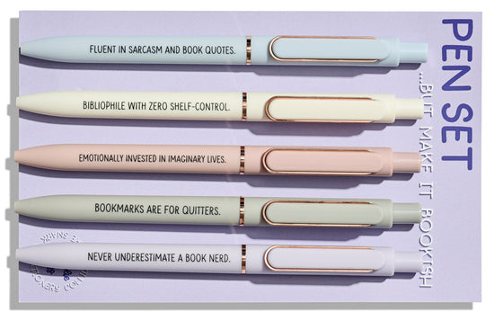 Bookish pen set of 5 ballpoint pens with funny reader quotes, displayed on a purple backing card with pastel pens and rose gold accents.