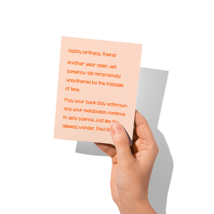 Funny birthday card held in hand, humorous Paul Rudd aging joke.