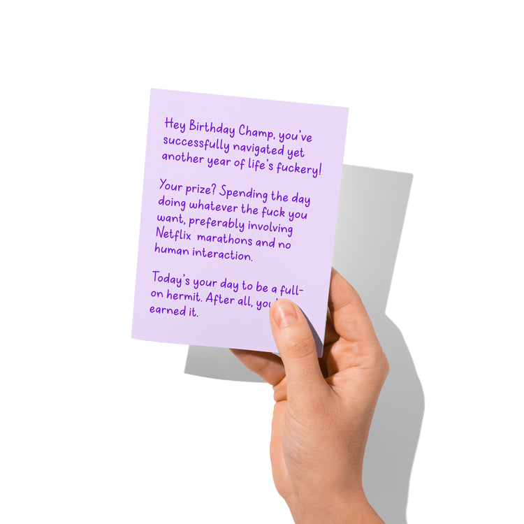 Funny birthday card held in hand, humorous snarky birthday message.