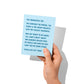 Funny graduation card held in hand, humorous graduation humor message visible.