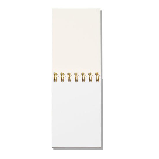 White notepad with gold rings on a white background