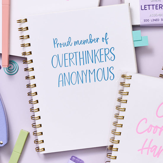 Funny overthinking notebook with rigid matboard cover, gold Wire-O binding, and hand-printed letterpress design.