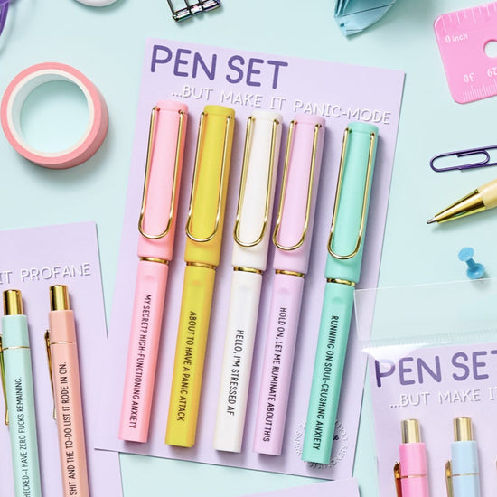 Funny gel pens with black ink and humorous stress-related phrases, packaged in a 5-pack set.
